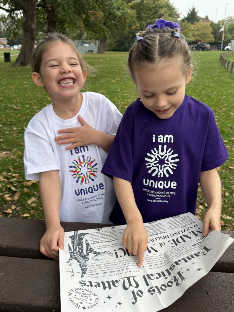 Magical Newspaper teaching genetics, disability and inclusion being read by children with Unique tshirts that represent the charity, Unique.